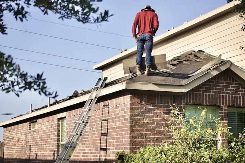 Professional roofer working on a residential roof in Sunset Valley